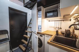a small kitchen with a sink and a microwave at City Apartments in Tallinn