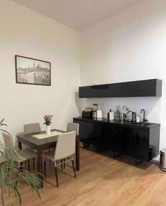 a dining room with a table and a table and chairs at Fleck Apartment 1 in Trenčín