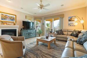 a living room with a couch and a tv at Luxury Cearra Del Ray Townhome Seconds to Beach 2-Car Garage in New Smyrna Beach