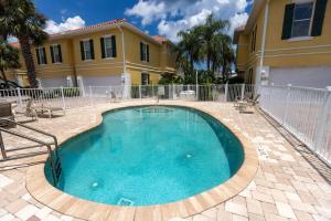a swimming pool in front of a house at Luxury Cearra Del Ray Townhome Seconds to Beach 2-Car Garage in New Smyrna Beach