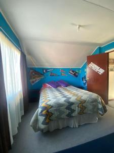 a bedroom with a bed with a fish wall at Calor y amor de hogar chilote in Castro