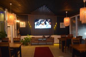 a dining room with a tv on the wall at istanbul Airport Kumsal Otel in Arnavutköy