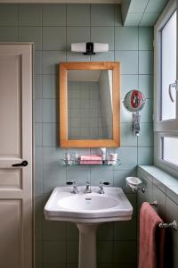 a bathroom with a sink and a mirror at Hôtel de La Boétie in Paris +72 photos