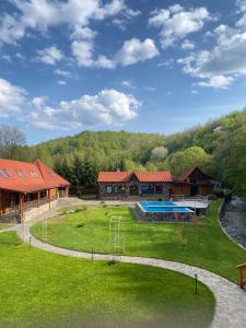 a house with a large yard with a swimming pool at Darino in Rodnikovka