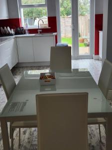 a kitchen table with chairs and a bowl of food on it at Chi Lodge & Accommodation in Rainham