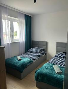 Leśne Wzgórze Apartamenty客房内的一张或多张床位