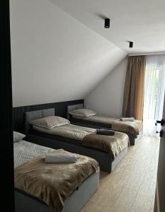 Leśne Wzgórze Apartamenty客房内的一张或多张床位