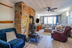 a living room with a stone wall and a wood stove at Sunset View in Hazelhurst