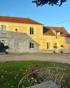 a stone building with a bench in front of it at La Gouronerie in Parçay-sur-Vienne +24 photos
