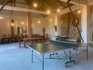 un tavolo da ping pong in una grande sala con tavoli e sedie di Agroturystyka Smulsko a Przykona