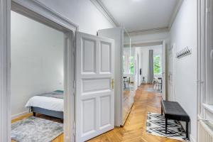 a white door in a bedroom with a bed at Szondi Residence in Budapest