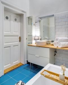 a bathroom with a sink and a mirror at Szondi Residence in Budapest