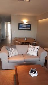 a living room with a couch and a table at FULLY RENOVATED APT BY THE OCEAN in Punta del Este