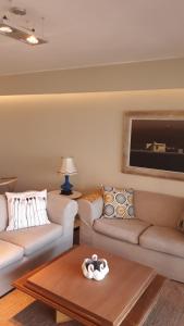 a living room with two couches and a coffee table at FULLY RENOVATED APT BY THE OCEAN in Punta del Este