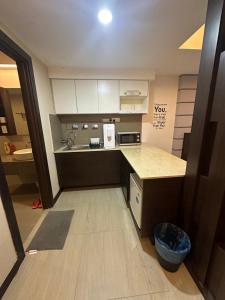 a small kitchen with a counter and a sink at Sweet Studio Apartment in Kota Bharu