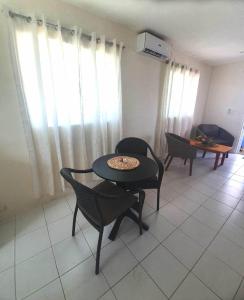 a living room with a table and chairs in a room at Wolfgramm Beachfront Motel in Utungake