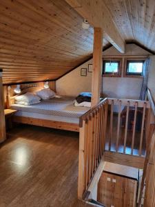 a room with a large bed in a wooden cabin at Cozy mountain house in Jämtland in Vallrun