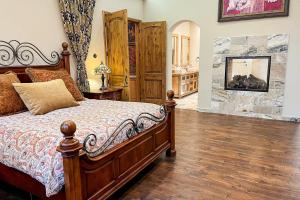 a bedroom with a bed and a wooden floor at Mediterranean Mountain Memories in Colorado Springs