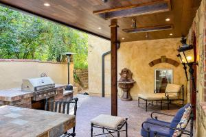 an outdoor patio with a grill and a table and chairs at Mediterranean Mountain Memories in Colorado Springs