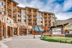 a large building with a courtyard in front of it at Canyons Resort Village #129 in Park City