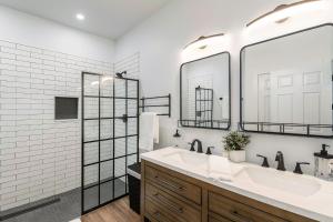 a bathroom with a sink and two mirrors at Welcome! 4 bedroom (6 bed) 3 bath River House in Sedalia +34 photos