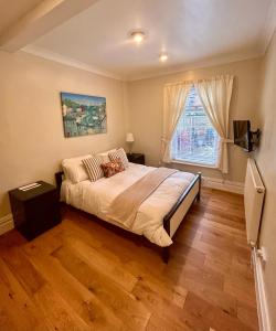 a bedroom with a large bed and a window at Holland House in New Brighton