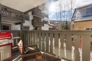 a patio with a chair and a stove on a balcony at 9 Vail Road Vail Village 2 to 4 Bedrooms by Vail Realty in Vail