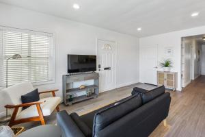 a living room with a couch and a tv at Beachside Oasis in Seal Beach