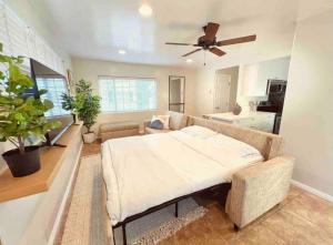 ein Wohnzimmer mit einem Bett und einer Couch in der Unterkunft Historical Beach Bungalow Steps Away From Sand #5 in Newport Beach