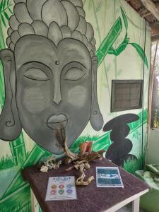 Una pared con una pintura de una cara. en Lunazul Eco-Cabaña Frente al Mar, en Mahahual