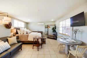 a living room with a bed and a couch at Adorable Tucson Studio with Gas Grill and WiFi! in Tucson