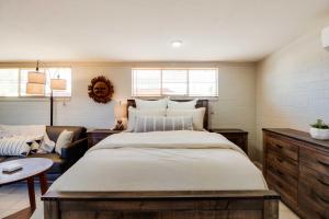 a bedroom with a large bed and a couch at Adorable Tucson Studio with Gas Grill and WiFi! in Tucson