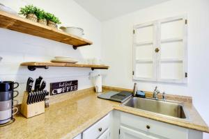a kitchen with a sink and a counter top at Adorable Tucson Studio with Gas Grill and WiFi! in Tucson +18 photos