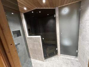 a shower with a glass door in a bathroom at Ruka Saaruakuja 3 as 1-4 in Ruka