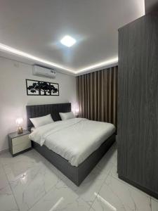 a bedroom with a large bed in a room at cozy rooftop near al services 24 in Rujm ash Sharāʼirah