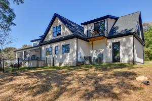 een groot wit huis met een zwart dak bij The Retreat at Lake Norman with Shared Dock and Slip in Mooresville