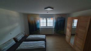 a bedroom with two beds and a window at Alpenblick in Leutkirch im Allgäu