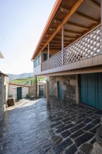 a patio with a deck on top of a building at Provesende Douro Villas in Provesende