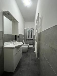 a bathroom with a sink and a toilet and a mirror at Inalpi Arena ex Pala Alpitour Stadio Olimpico SEBA159 in Turin