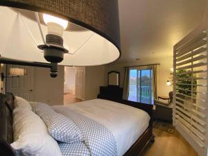 a bedroom with a large bed and a large lamp at Golf course house with 2 Master Bedrooms in Fontana