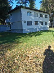 a shadow of a person in front of a building at Teslić Apartman NiA in Teslić