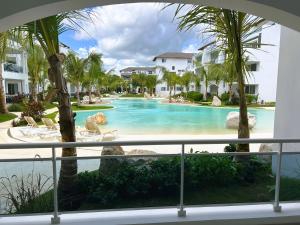 a view of a swimming pool from a balcony at Komfortowy Apartament z 4 Basenami i Pięknym Ogrodem, Estrella Dominicus-Bayahibe in Bayahibe