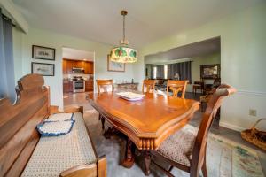 a dining room with a wooden table and chairs at Cozy Ripley Apartment - 21 Mi to Downtown Erie! in North East