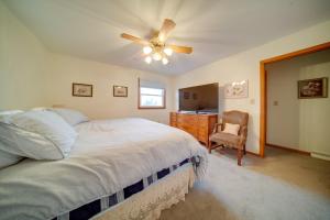 a bedroom with a bed and a ceiling fan at Cozy Ripley Apartment - 21 Mi to Downtown Erie! in North East