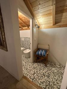 a bathroom with a toilet and a bench in it at Residenza ammiraglio Filippo in Varigotti