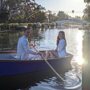 a man and woman in a boat on the water at Venice Canals & Beach Guest House in Los Angeles