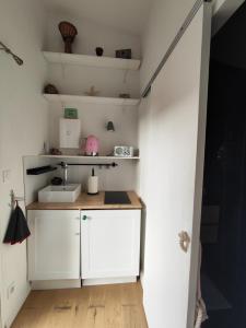 a small kitchen with a sink and a counter at Bienvenu in Bouguenais