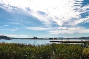 a large body of water with a cloudy sky at Charming Hideaway Overlooking The Astoria Waters in Astoria, Oregon