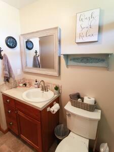 a bathroom with a toilet and a sink and a mirror at Historic Astoria Waterfront Views & Vintage Vibes in Astoria, Oregon
