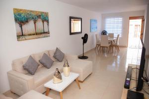 a living room with a couch and a dining room at CASA PETRA in Cartagena de Indias